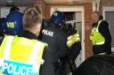 Police raid a property as part of a modern slavery investigation