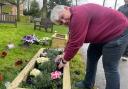 Weasenham parish councillor Jacqueline Hargreaves has rolled her sleeves up to plant up the new planters