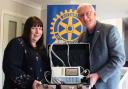 Lisa Drewry, practice manager at the Fakenham Medical Practice, with the ECG machine presented to her by Tony Grover, president of the Fakenham and District Rotary Club.