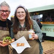Gary Arlow and his daughter Joely Carter with loaded fries and a cake from their new venture Birdys Bakehouse at Blakeney Quay.