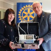 Lisa Drewry, practice manager at the Fakenham Medical Practice, with the ECG machine presented to her by Tony Grover, president of the Fakenham and District Rotary Club.