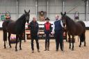 Wakefield Farm Stud and Livery owner Neil Holden (left) with stud manager Tom Saunders and head groom Jo Durrell with two of their horses in the indoor arena