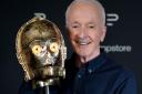 Actor Anthony Daniels looks at the head from his C-3PO costume (Andrew Matthews/PA Wire