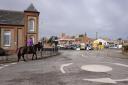 Looking up Stalham's high street as a horse is ridden through the town