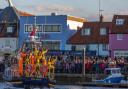 Thousands of people on Wells Quay cheer as the new lifeboat Duke of Edinburgh arrives in the town on October 8
