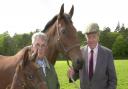 Sir Michael Oswald (right) and Brand, one of the Queen's mares, with her foal held by stud groom Bob Rowlands