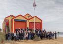 RNLI Wells crew members and their families at the old lifeboat station before the flag was lowered for the final time