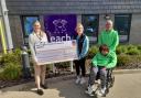Nick & Elaine Loades and Kyra Welch with EACH Community Fundraiser Ellie Miller (presenting a cheque for £27,659)