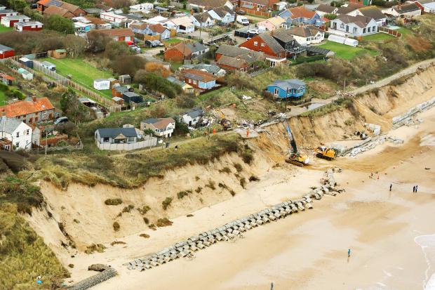 More than a thousand homes are at risk from coastal erosion, a new report warns