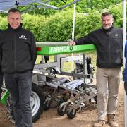 The Normac robotic farm machine demonstration at Hempton, near Fakenham. With the Farmdroid machine are Ernest Doi, Michael Massingham, Jim Pamment, and Richard Perry