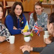 A new support hub for Ukrainian refugees has opened in Dereham Baptist Church. Some of the refugees gather to chat over tea and cake during the first event.