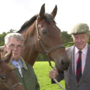 Sir Michael Oswald (right) and Brand, one of the Queen's mares, with her foal held by stud groom Bob Rowlands