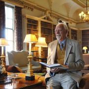 Sam Mortlock with a copy of his book inside The Long Library, Holkham Hall, in 2007