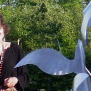 The sculptor Ros Newman has died aged 82. Here she is photographed with her famous sculpture, the Flight of Birds, which is on display at the Norfolk and Norwich University Hospital