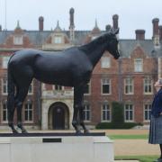 The statue of Estimate that stands proudly outside Sandringham House. Also pictured is Sandringham Estate public enterprises manager Helen Walch. Picture: Ian Burt