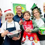Sandie Toher (rear middle), chairman of the Friends of Fakenham Junior School, joined staff from The Nottingham and school pupils Taylor, Lewis and Bethany to celebrate the donation