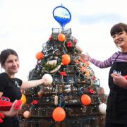 Gabrielle Bird, left, and Joanna Barton, with the annual crabpot Christmas tree at Wells-Next-the-Sea.