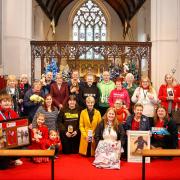 Charity volunteers and Reverend Tracy Jessop (centre) at a Fakenham Parish Church service during the Fakenham Christmas Tree Festival