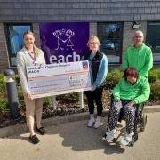 Nick & Elaine Loades and Kyra Welch with EACH Community Fundraiser Ellie Miller (presenting a cheque for £27,659)