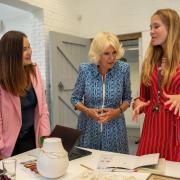 Founder Monica Vinader (left) shows Queen Camilla (centre) her jewellery during a visit to Monica Vinader's design studio